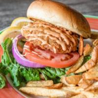 Crab Cake · Lump crab cake with lettuce, tomato, and onion on a buttery knot roll.
