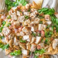 Nachos · Freshly fried chips topped with your choice of seasoned ground beef or chicken with lettuce,...