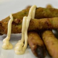 Fried Green Beans · Prepared southern style with a seasoned cornmeal coating and served with pink lady sauce.