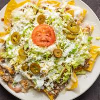 Nacho Especial · Topped with chicken and steak, refried beans, then covered with lettuce, tomatoes and sour c...