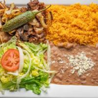 Carnitas Dinner · Fried pork tips sautéed with grilled onions. Served with rice, refried beans and salad.