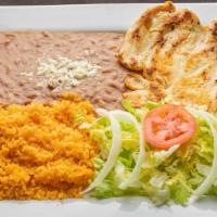 Pollo A La Parrilla · Grilled chicken breast. Served with rice, refried bean and salad.