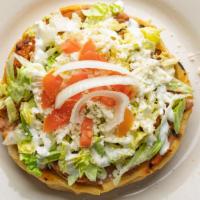 Sopes · Served with beans, lettuce, tomatoes, sour cream and queso fresco.