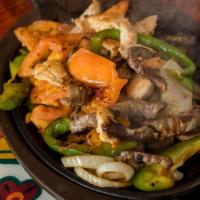 Fajita Grande · Combination of shrimp, steak, chicken breast, and vegetables. Served sizzling hot with guaca...