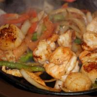 Fajitas De Camarones · Grilled shrimp and mixed vegetables. Served sizzling hot with guacamole, sour cream, pico de...