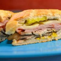 Cuban · A traditional Cuban sandwich made on authentic Cuban bread. Made with sliced roasted pork, s...