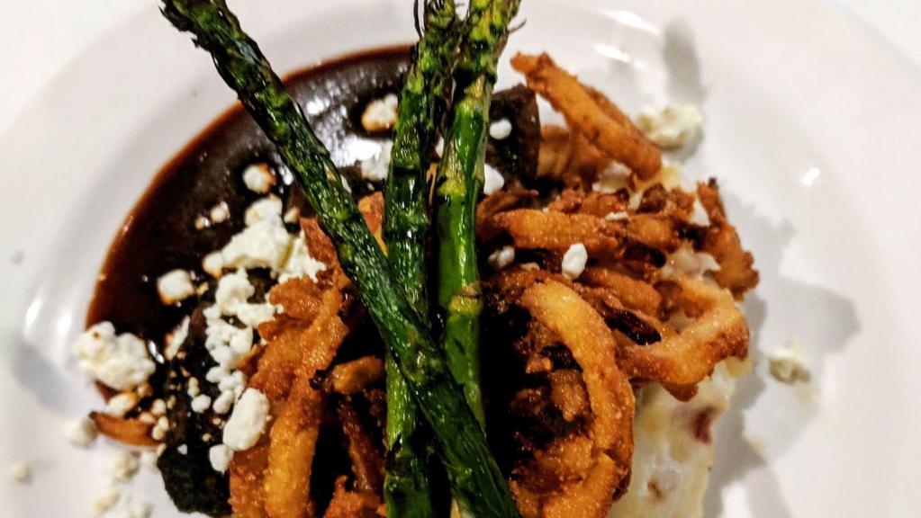 Petite Filet Medallions And Mashed Potatoes · 6 oz of sliced petite medallions, grilled and served over mashed potatoes with a roasted garlic red wine demi-glaze, goat cheese crumbles, and fried onion strings.