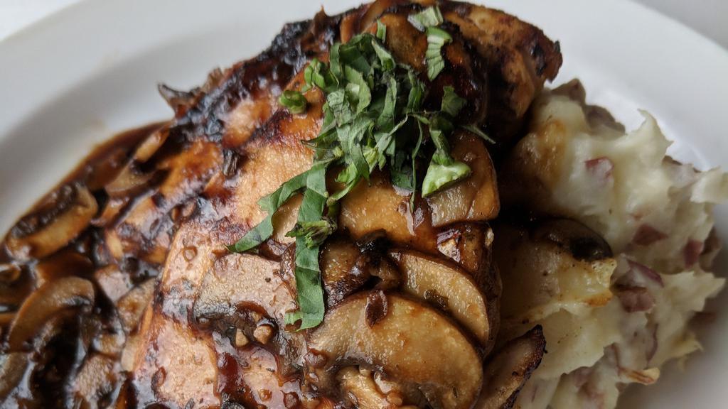 Portobello Chicken And Mashed Potatoes · Two marinated grilled chicken breasts over red mashed potatoes, smothered with sautéed baby portabello mushrooms in a roasted garlic red wine demi-glaze sauce.