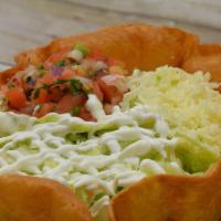 Taco Salad · A fried tortilla shaped like a bowl, filled with choice of ground beef or shredded chicken a...