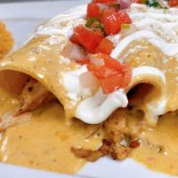 Enchiladas Chipotle · 3 enchiladas. 1 shredded beef, 1 ground beef, and 1 chicken, topped with chipotle sauce, sou...