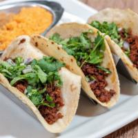 Tacos Chorizo · 3 tacos served with rice, beans, cilantro, and onions.
