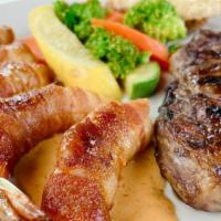 Steak & Bacon Shrimp · 10 oz Ribeye-steak with 6 shrimp wrapped in bacon and cheese on chipotle sauce. Served with ...