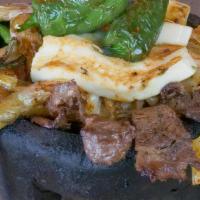 Molcajete Special · A hot stone bowl filled with rib-eye steak, chicken, shrimp, bell peppers, slice of pineappl...
