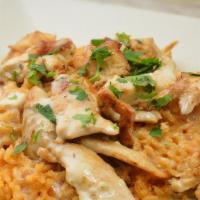 Arroz Con Pollo · Grilled chicken over a bed of rice topped with cheese dip.