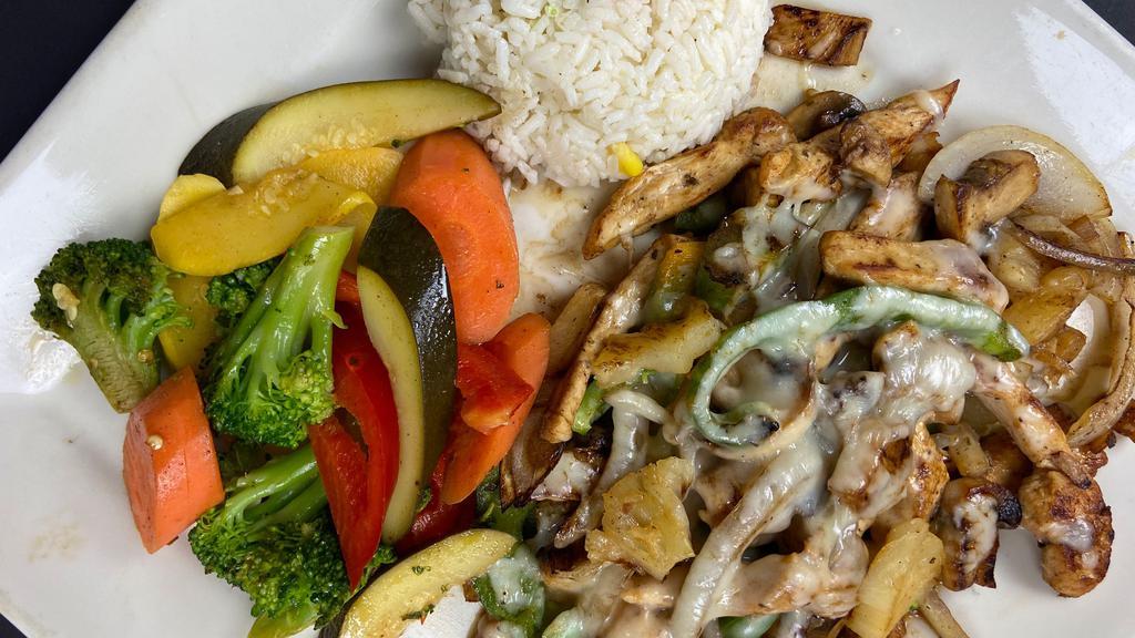Pollo Hawaiiano · Grilled marinated chicken strips cooked with poblano peppers, mushrooms, onions, pineapple chunks, and melted cheese. Served with rice and steamed vegetables.