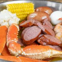 Signature Combo A · 1/2 lb crab legs, 1/2 lb shrimp, 1/2 lb sausage. Comes with one egg, one corn, and two potat...