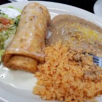 Chimichanga, Mexican Rice & Beans · A flour tortilla stuffed with your choice of steak chunks or chicken, then deep-fried to a g...