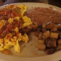 Huevos Rancheros · Ranch-style eggs topped with Mexican sauce and served with Mexican rice, beans and two flour...