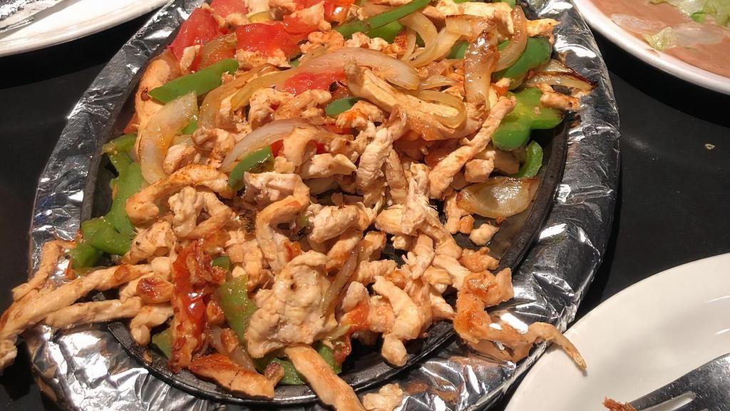 Chicken Fajitas · This is where the party begins! Everyone loves our fajitas. It’s that delicious aroma as they rush the sizzling plate to your table. The colorful blend of peppers, tomatoes and onions and of course, the great taste that makes them so popular.