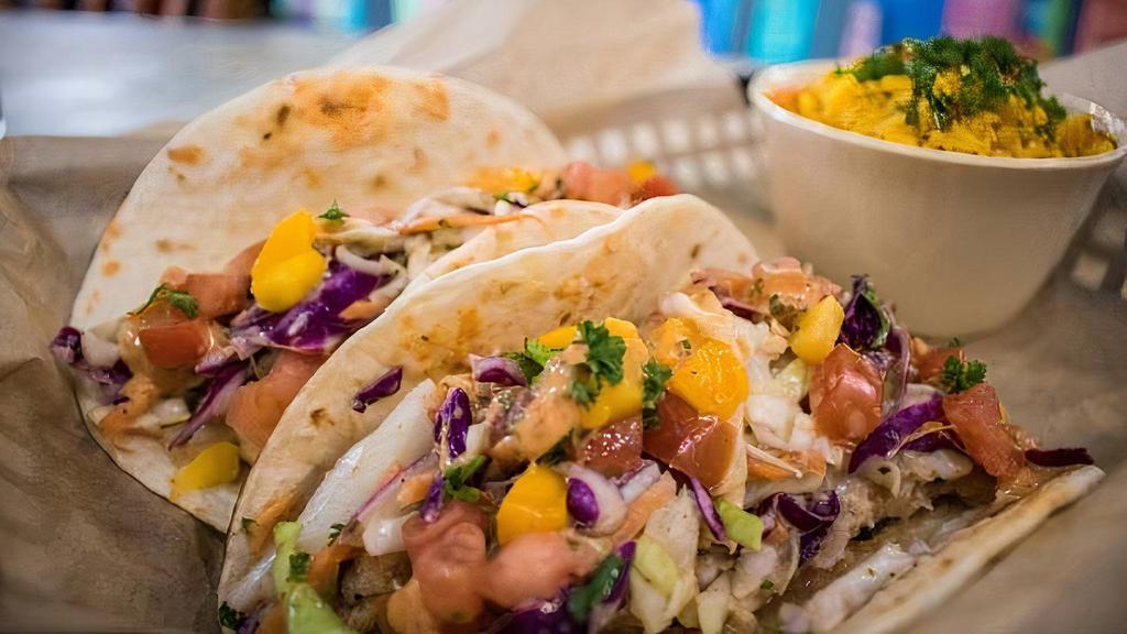Fish Tacos · something's fishy around here and it's not just your breath. These delicious fish tacos are made with coconut fried cod, shredded cabbage, diced tomatoes, diced mango, and chipotle crema.