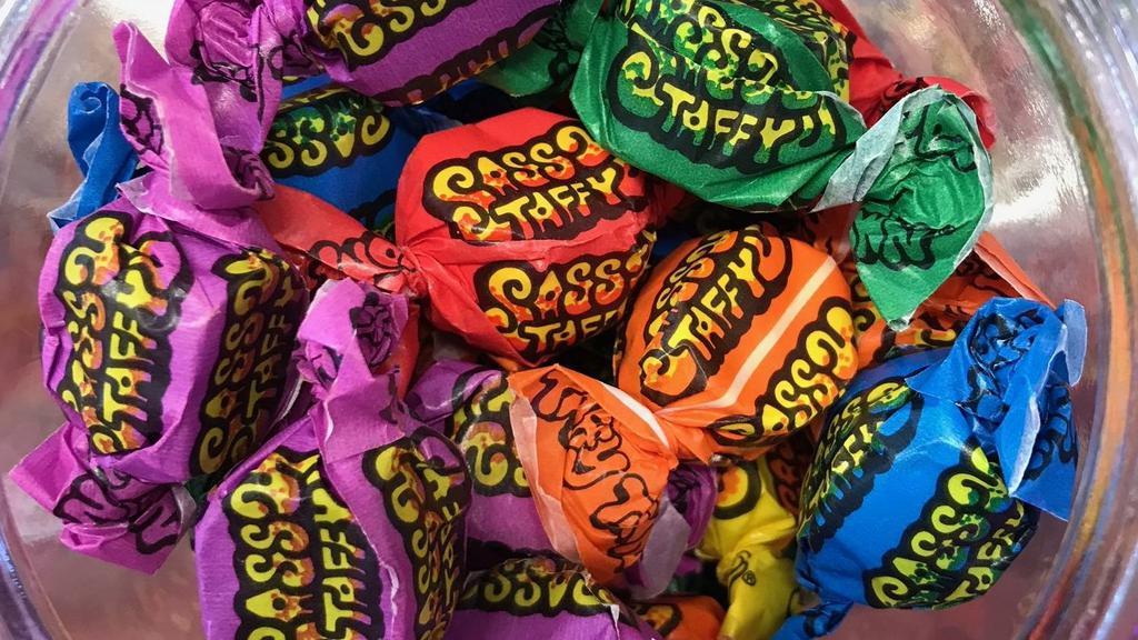 Sassy Saltwater Taffy (Tart-Sour)- 8 Oz. · Taffy Town Sassy Saltwater Taffy - 8 oz. - 1/2 pound - 32 pieces.

Looking for some tart taffy that will be sure to pucker any mouth? Look no further than Sassy Taffy. Enjoy classics like Lemon, Orange, Green Apple, Cherry, Raspberry, and Grape all with a more intense sassy sour flavor!
Ingredients: CORN SYRUP, SUGAR, COCONUT OIL, CITRIC ACID, SEA SALT, EGG WHITES, MALIC ACID, EVAPORATED MILK|NATURAL AND ARTIFICIAL FLAVOR, ARTIFICIAL COLOR (INCLUDING FD&C RED 40)