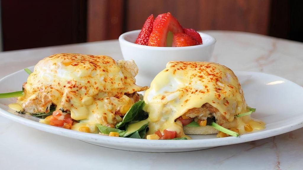 Bay Benedict · Lump crabcake, english muffin, baby spinach, diced tomatoes, roasted organic corn, basil, cage-free Amish eggs over-easy, hollandaise, Old Bay, fresh strawberries and fruit.