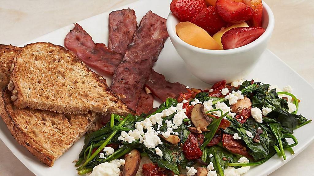 Power Breakfast · Egg whites topped with cremini mushrooms, spinach, roasted tomatoes, feta cheese, turkey bacon, fresh strawberries and fruit, whole wheat toast.