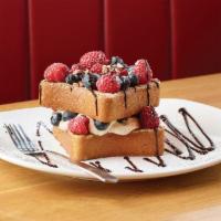 New! Red, White, And Blue French Toast · Cinnamon sugar crusted, fresh raspberries and blueberries, layered cinnamon cream, candied p...