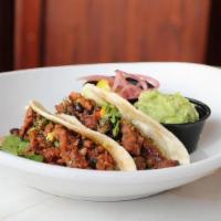 Meatless Tacos · Two bbq Beyond Meat tacos, guacamole, pickled ginger, black bean salsa, cilantro, flour tort...