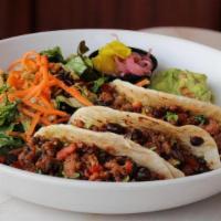 Meatless Taco Bowl · Three bbq Beyond Meat tacos, guacamole, pickled ginger, black bean salsa, cilantro, flour to...