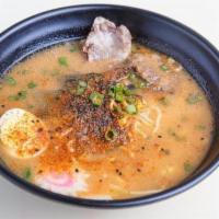 Spicy Tonkotsu Ramen · Spicy. Thick, red broth simmered with pork belly and bones. Served with traditional curly ra...