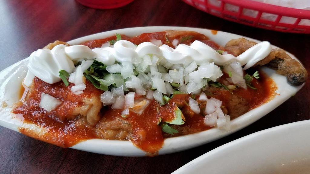 Chile Relleno · One Chile Relleno topped with red sauce, sour cream, cilantro and onions.