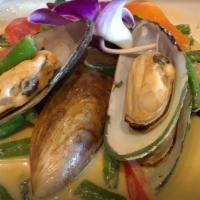 Green Curry Mussels · mussels with green curry sauce and basil.
