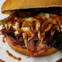 1/3 # Pulled Pork Sandwich · 1/3 # of slow smoked pulled pork on a bun with sauce, slaw, and pickle.