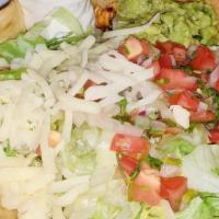 Taco Salad · Flour tortilla bowl filled with ground beef or shredded chicken, cheese, beans, lettuce, pic...