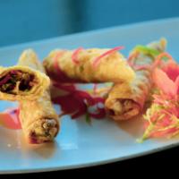 Spring Rolls · Golden-fried Chinese wraps with a savory filling of vegetables, accompanied with our homemad...