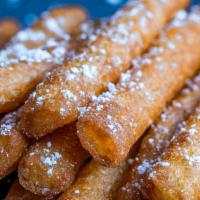 Funnel Cake Fries · Yummy warm funnel cake fries dusted with powdered sugar. Served with decadent caramel sauce ...