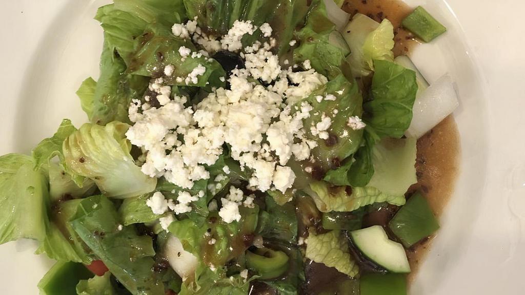 Greek Salad · Fresh romaine lettuce with cucumber, tomatoes, onions, feta cheese, spices and black olives drizzled with Greek dressing.