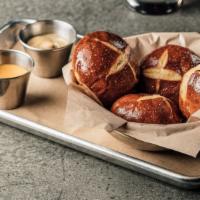 Pretzel Bread · Four mini buns served hot from the oven with a side of cheese sauce & Sierra Nevada Beer mus...