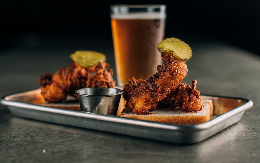 Nashville Hot Chicken Tenders · We use hand breaded tenders for our spin on this classic dish. Just enough heat to keep you wanting more. Served with fresh bread, pickles & a side of house-made ranch to help balance it out.
