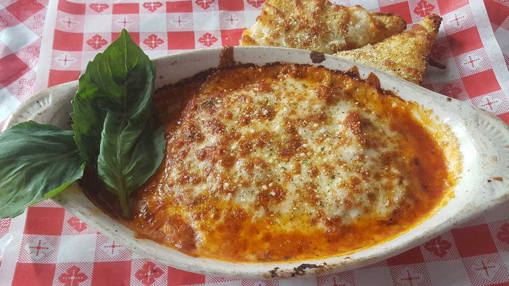Martha'S Lasagna · Layers of pasta with cheese and meat sauce topped with  mozzarella, served with garlic bread and a side salad