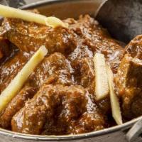 Goat Punjabi · Goat cooked in a curry sauce.