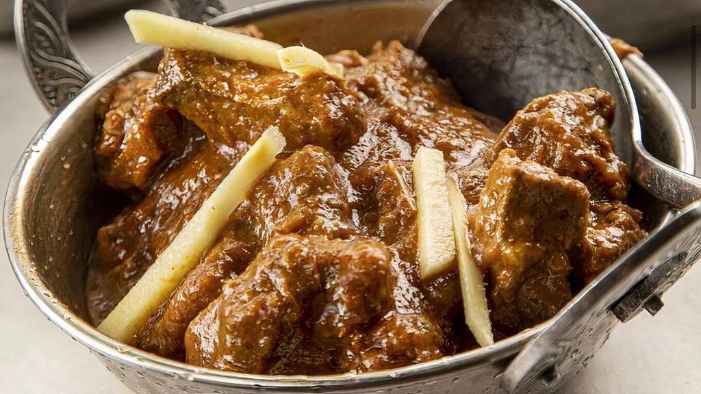 Goat Punjabi · Goat cooked in a curry sauce.