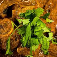 Goat Vindaloo · Goat cooked with spices in a spicy gravy sauce.