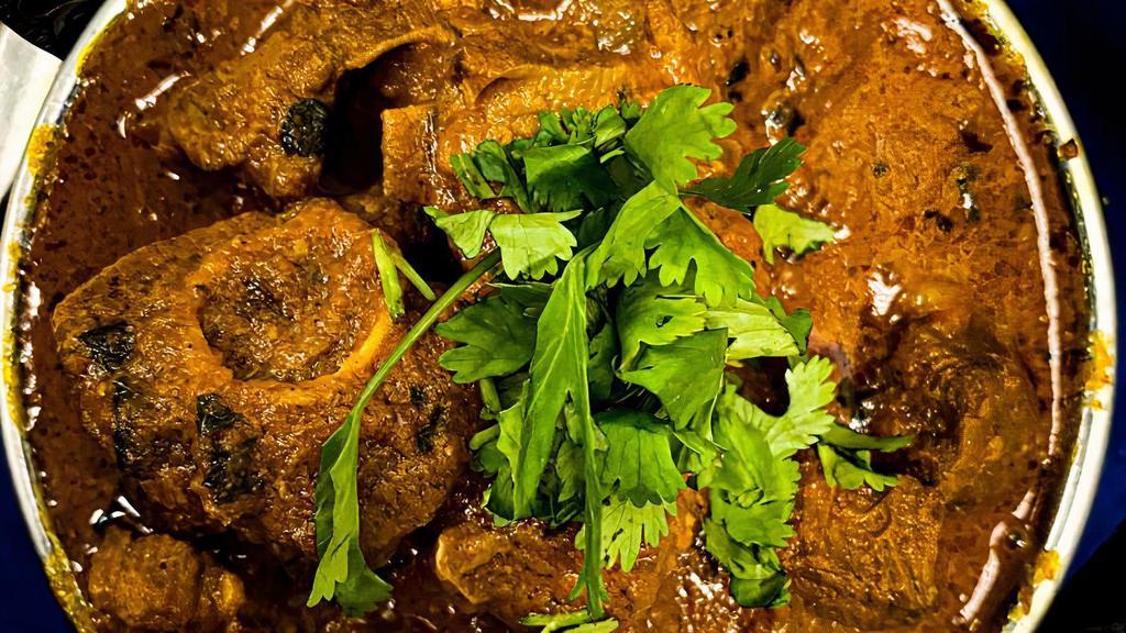 Goat Vindaloo · Goat cooked with spices in a spicy gravy sauce.
