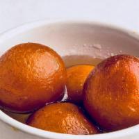 Gulab Jamun · Sweet pastry ball served in honey syrup.