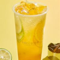 Passion Fruit Sparkling Tea · Sparkling green tea and passionfruit puree with fresh fruit and tea jelly