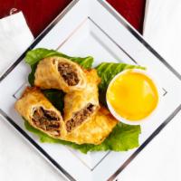 Steak Philly Egg Roll · Steak, peppers, onions and mozzarella cheese.  Served with Cheese sauce