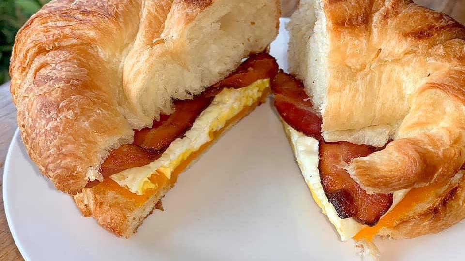 Bacon Egg & Cheese Croissant · Served on a fresh baked croissant, with thick cut applewood smoked bacon, fresh cracked egg, and sharp cheddar cheese.