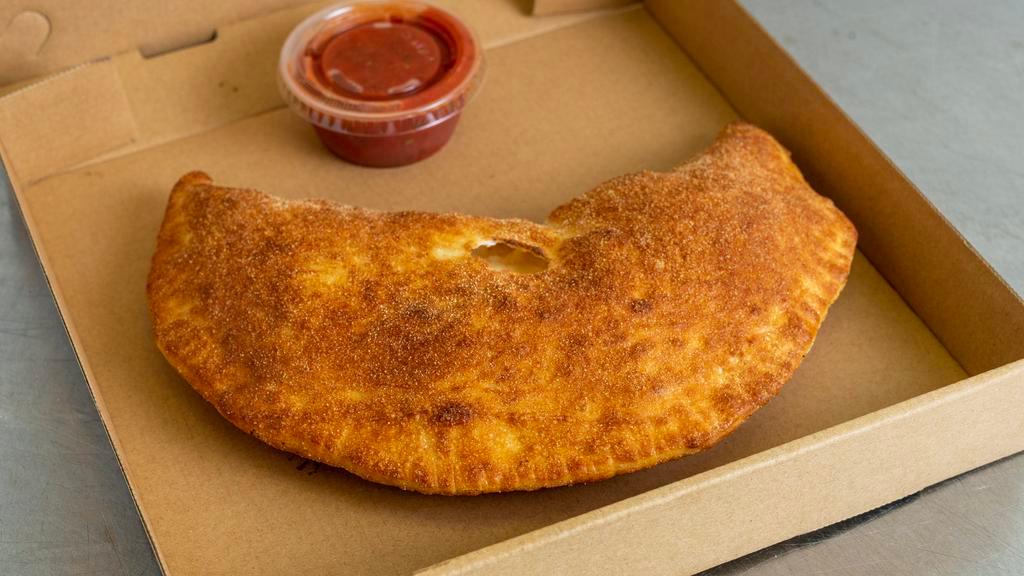 Small Calzone · Small Calzone is served wrapped in dough made daily at our shop.  Small Calzone is served with our mozzarella/provolone cheese blend, ricotta cheese, and one cup of our in house Marinara.  Add additional toppings for a charge